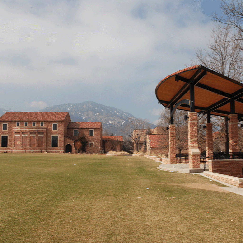 CU Boulder campus with mountain backdrop and red-brick architecture"