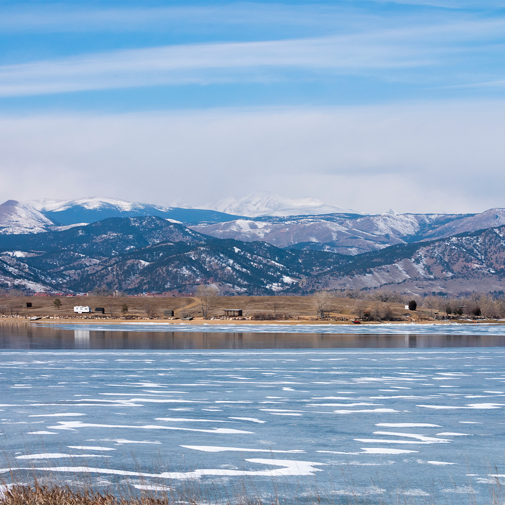 Frozen Baseline Reservoir with mountain backdrop