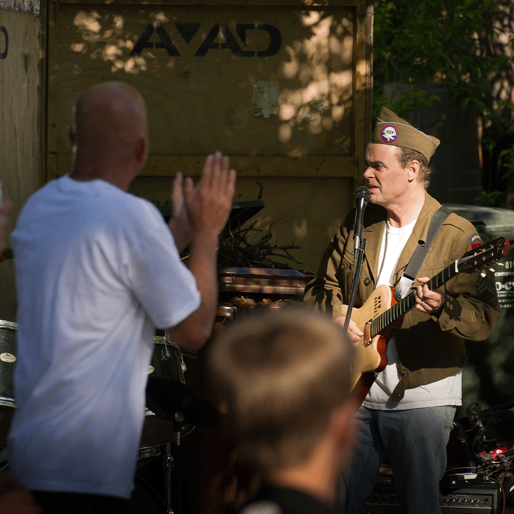 Boulder Creek Festival with crowds, tents, and entertainment by the creek.