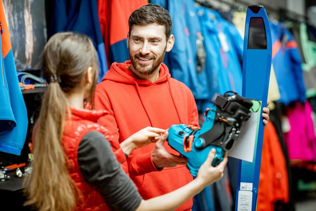 Man shopping for ski boots in store