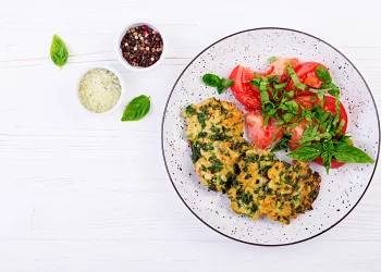Gluten-free chicken and spinach patties with fresh tomato salad