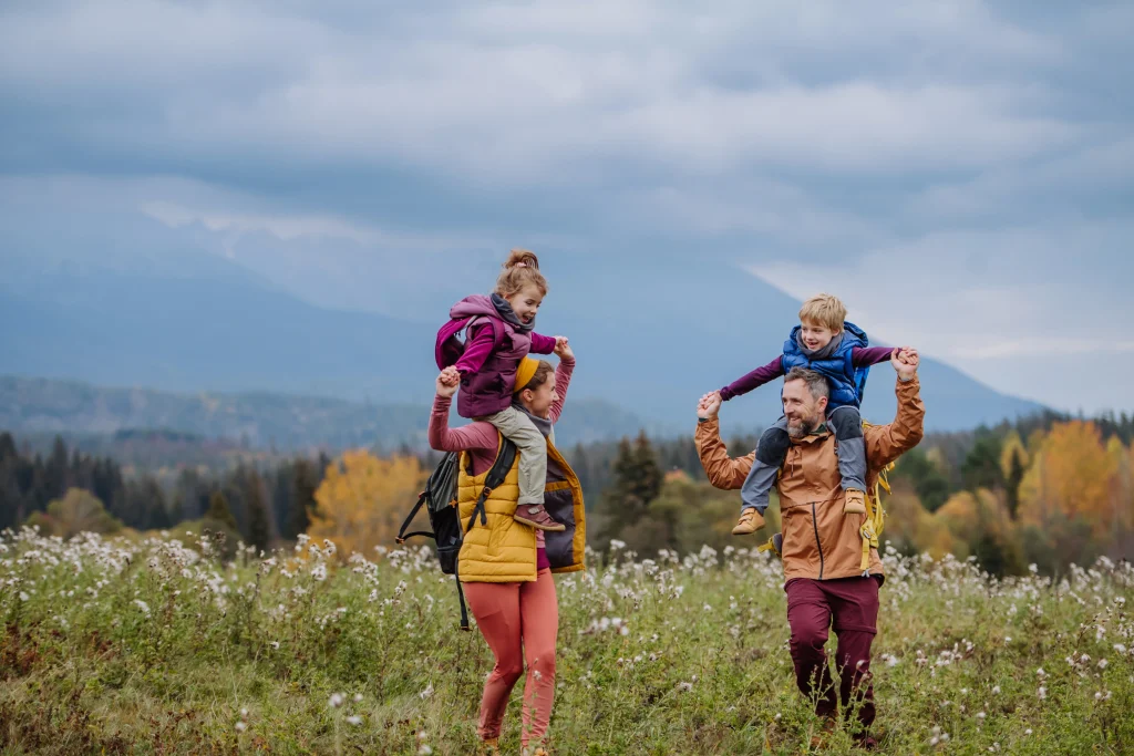 happy parents with kids hiking