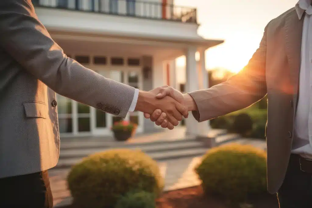 Two men in business attire are engaging in a handshake