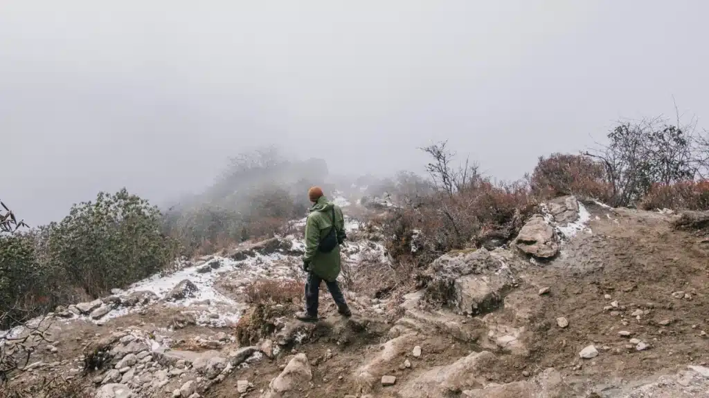 A hiker on a snowy trail