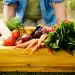 Wooden crate filled with a variety of fresh, organic vegetables
