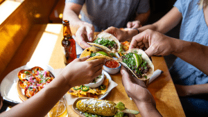Friends sharing Mexican food tacos at a Boulder Restaurant