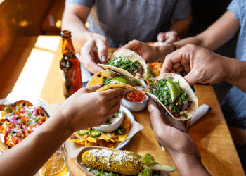 Friends sharing Mexican food tacos at a Boulder Restaurant