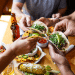 Friends sharing Mexican food tacos at a Boulder Restaurant