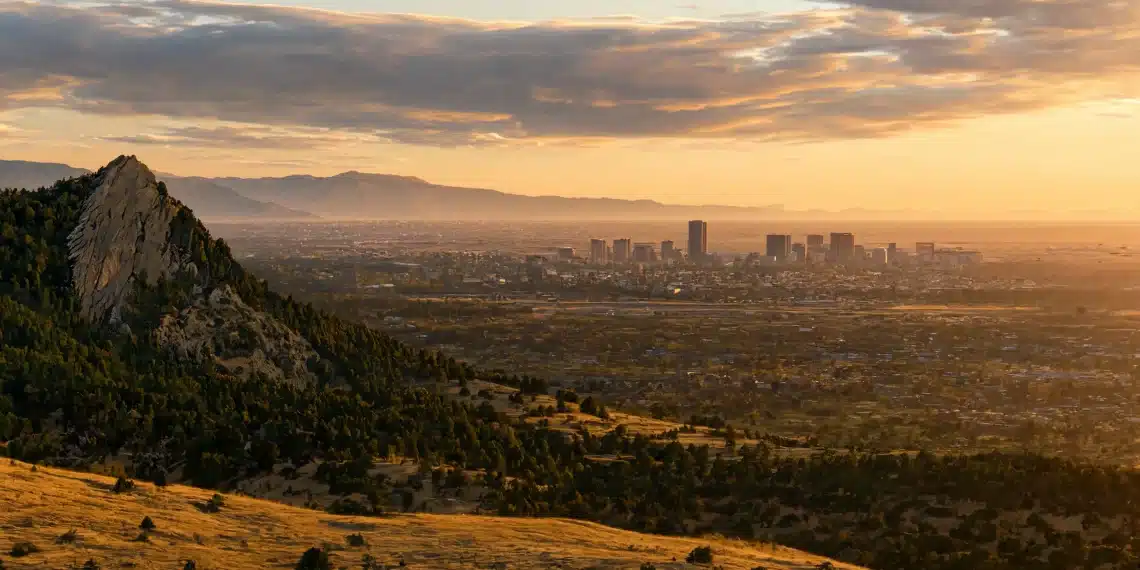 Boulder vs Denver — Flatirons and city skyline at sunset