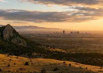 Boulder vs Denver — Flatirons and city skyline at sunset