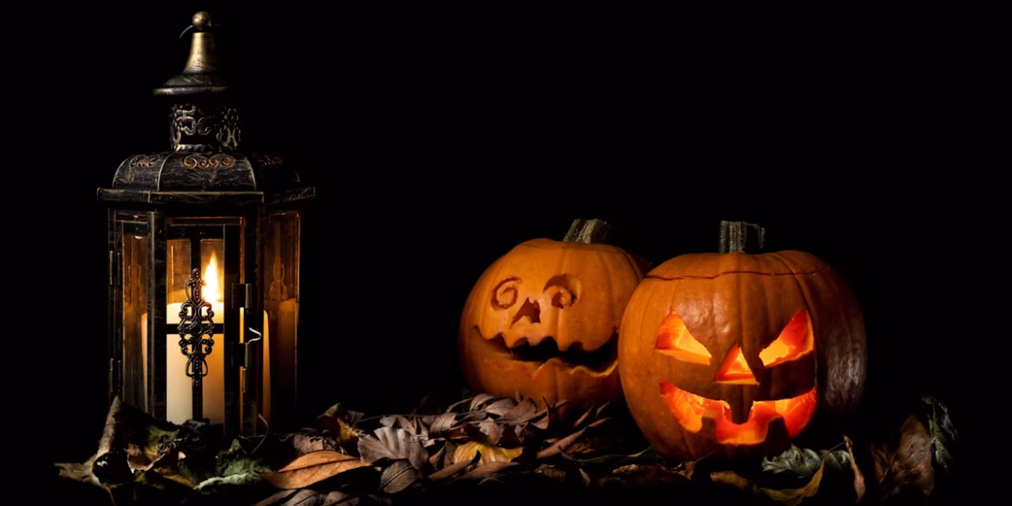 Halloween in Boulder carved pumpkins beside a lantern