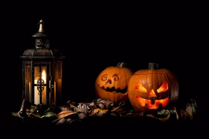 Halloween in Boulder carved pumpkins beside a lantern