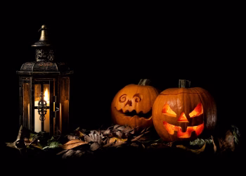 Halloween in Boulder carved pumpkins beside a lantern