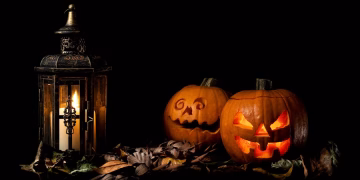 Halloween in Boulder carved pumpkins beside a lantern