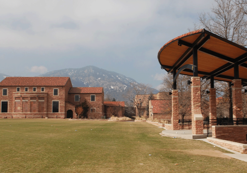 CU Boulder campus with mountain backdrop and red-brick architecture"