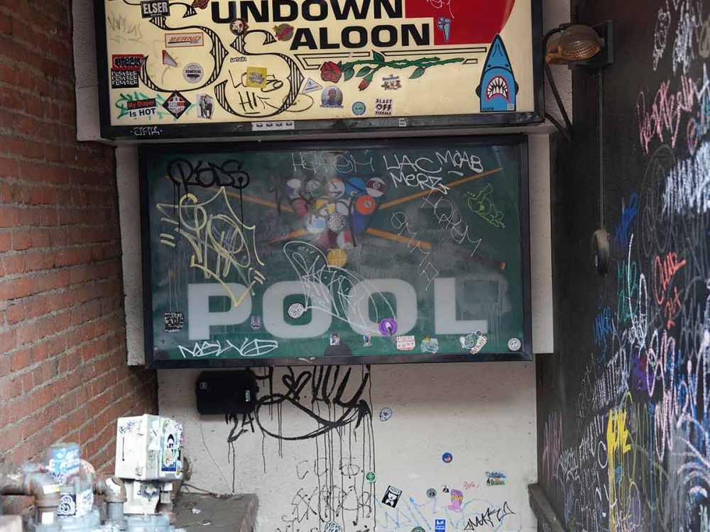Sundown Saloon bar entrance with graffiti and pool hall in Boulder